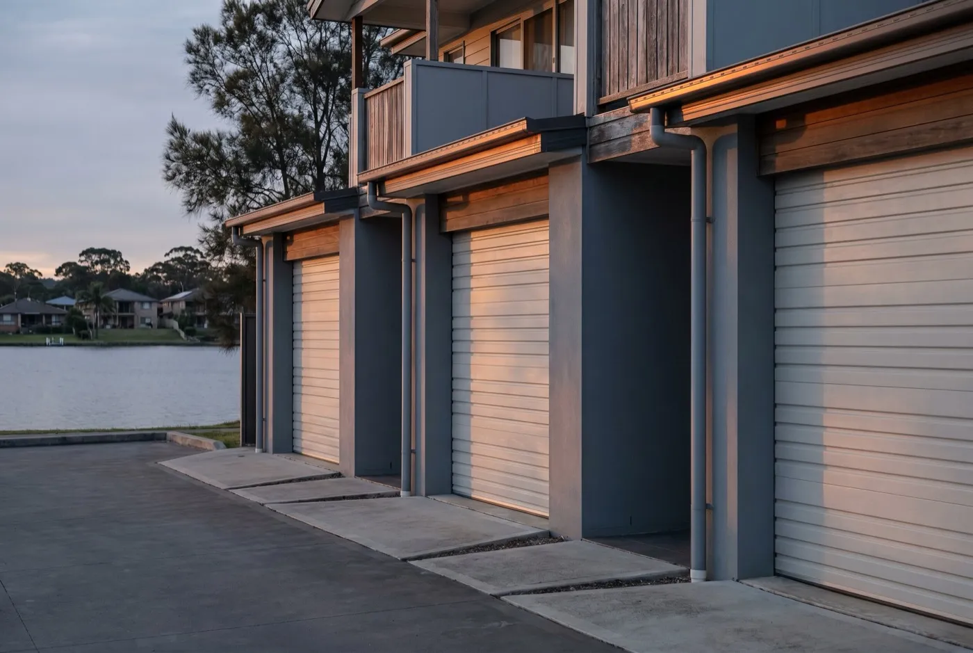 A row of townhouse garages with roller doors and close-set walls